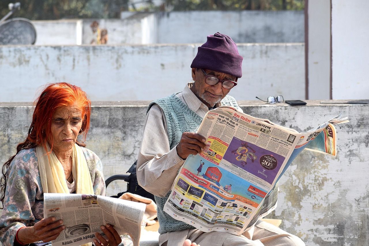 old couple reading newspaper 5051770